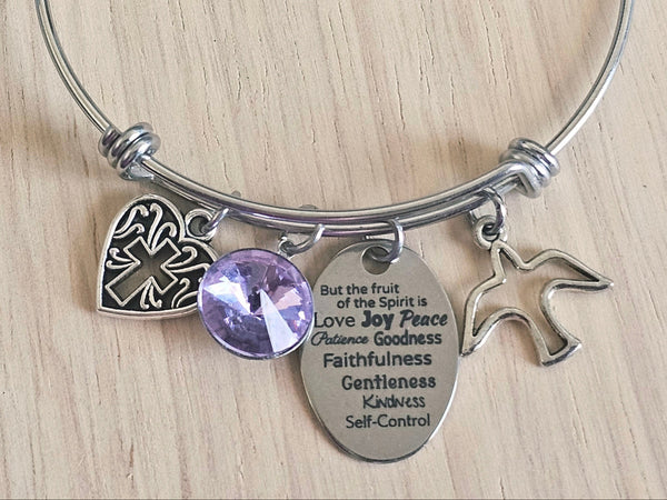 Silver bracelet with charms on a wooden surface